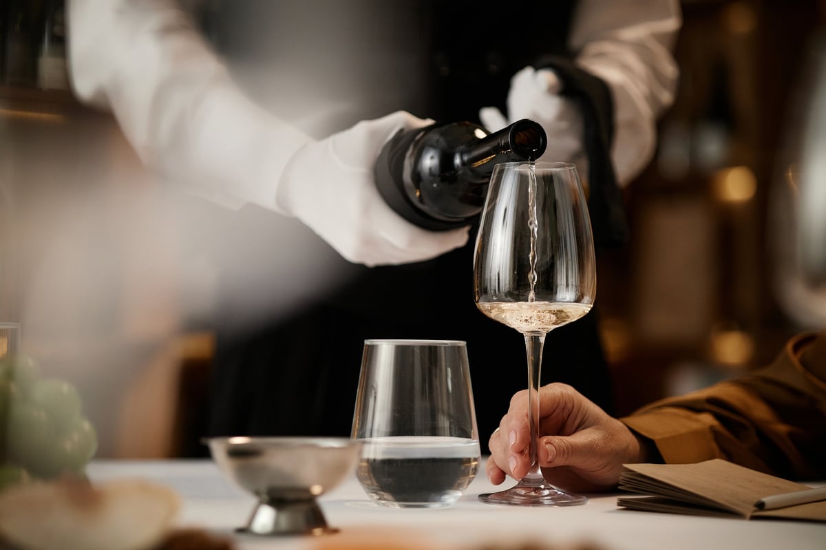 Sommelier pouring white wine during a tasting