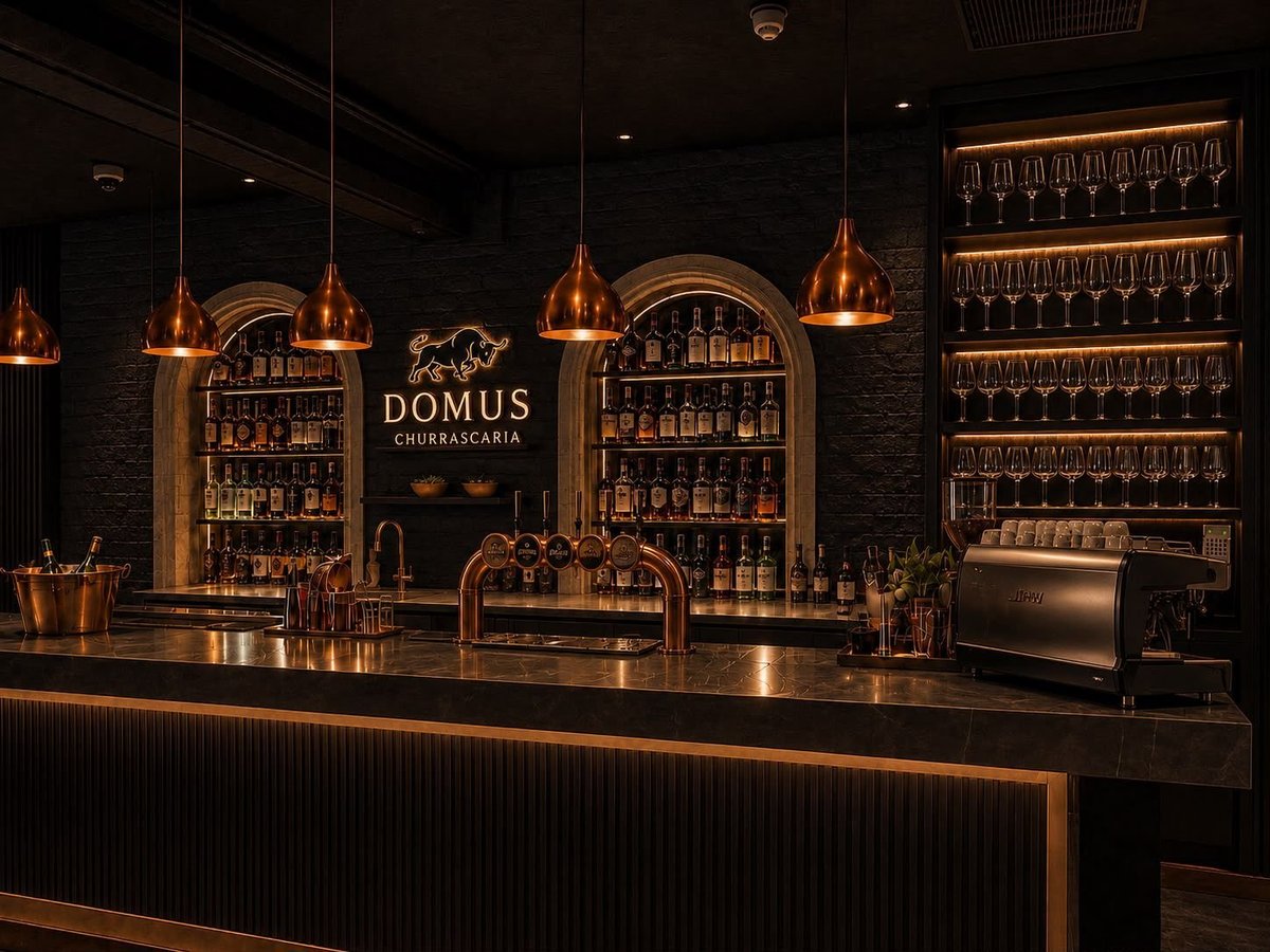 Luxury bar interior with dark walls, copper pendant lights, and rows of bottles lit by warm golden lighting with the Domus sign on the back wall