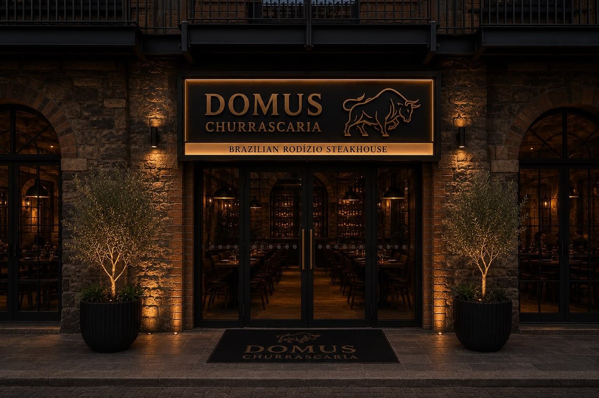 Domus Churrascaria Brazilian steakhouse storefront at night with illuminated signage and entrance